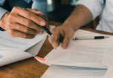 Two people reviewing a paper