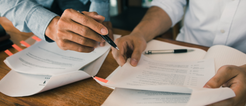 Two people reviewing a paper