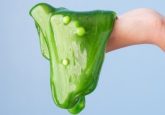 Hand holding green antibiotic-resistant slime