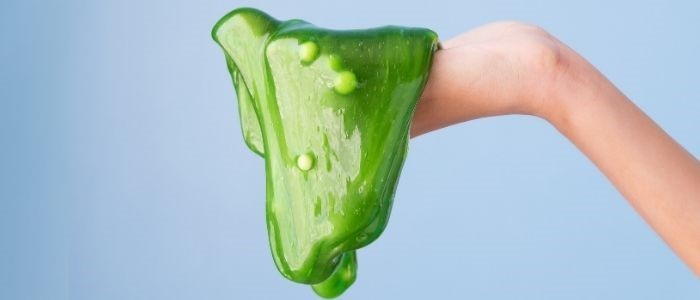 Hand holding green antibiotic-resistant slime