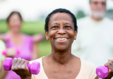 group of elderly people exercising with weights